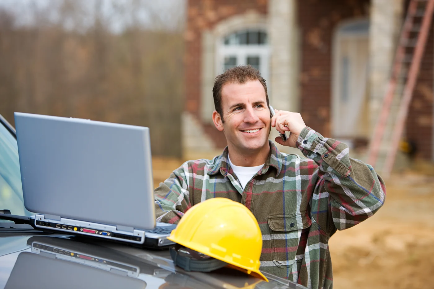 A friendly roofer talks on the phone with a homeowner in Austin, TX