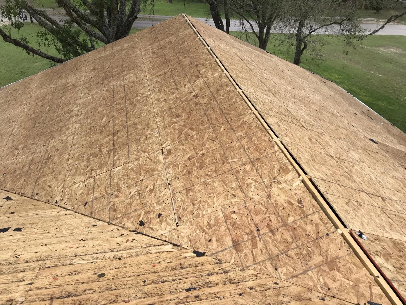 A close-up of a clean deck during a roof replacement.