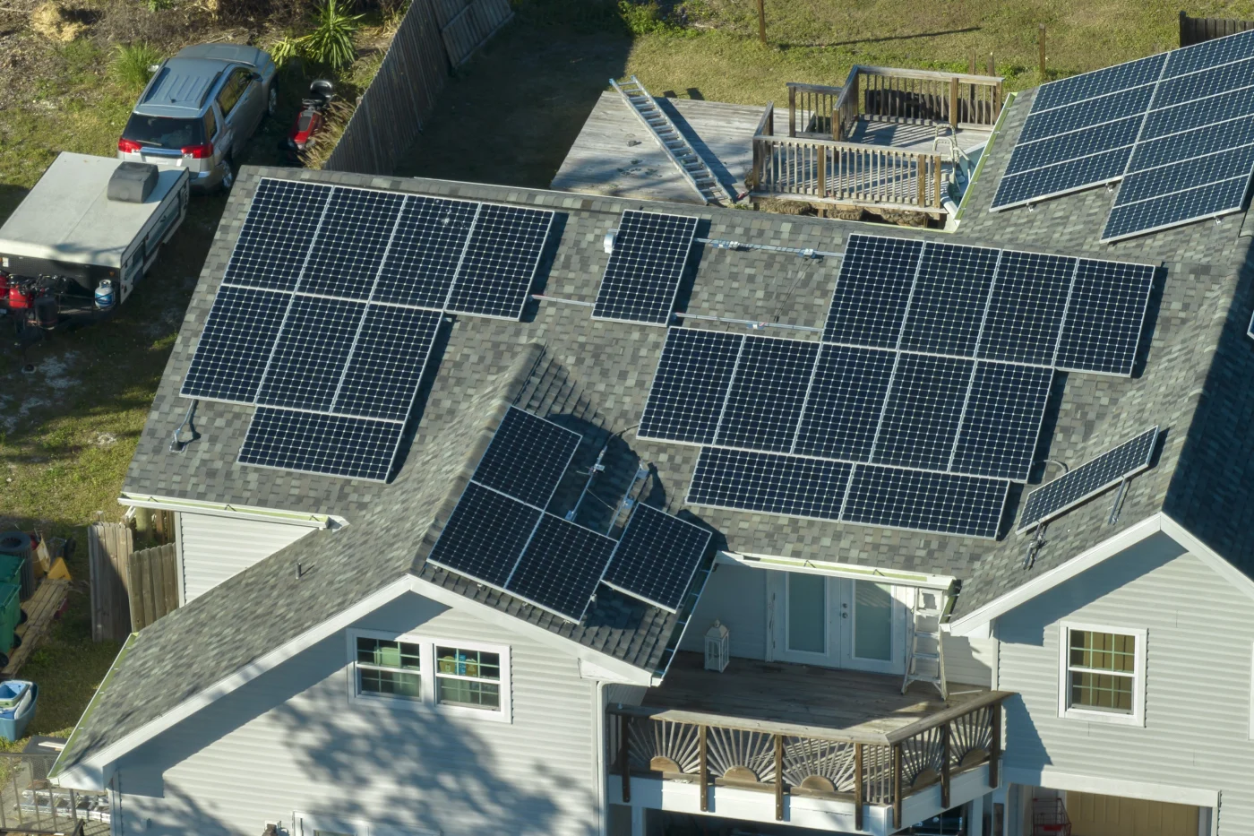 Close-up view of solar panel arrays mounted on an asphalt shingle residential roof, showing secure racking and clean alignment.