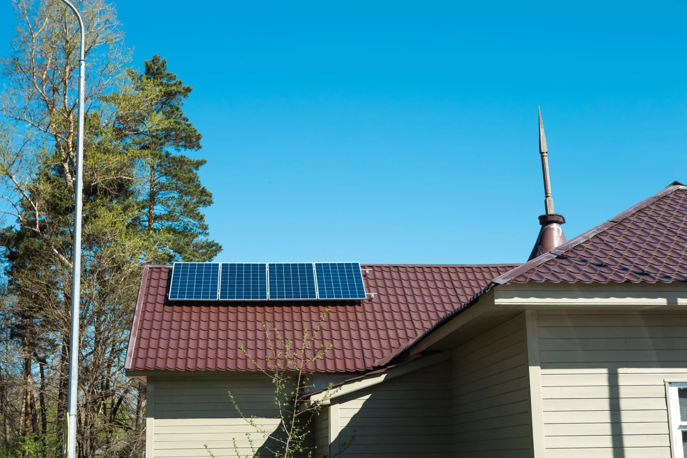 Premium Solar Roofing Bee Cave Tx Willi Roofing Small solar panel array mounted on a brown metal roof of a residential home