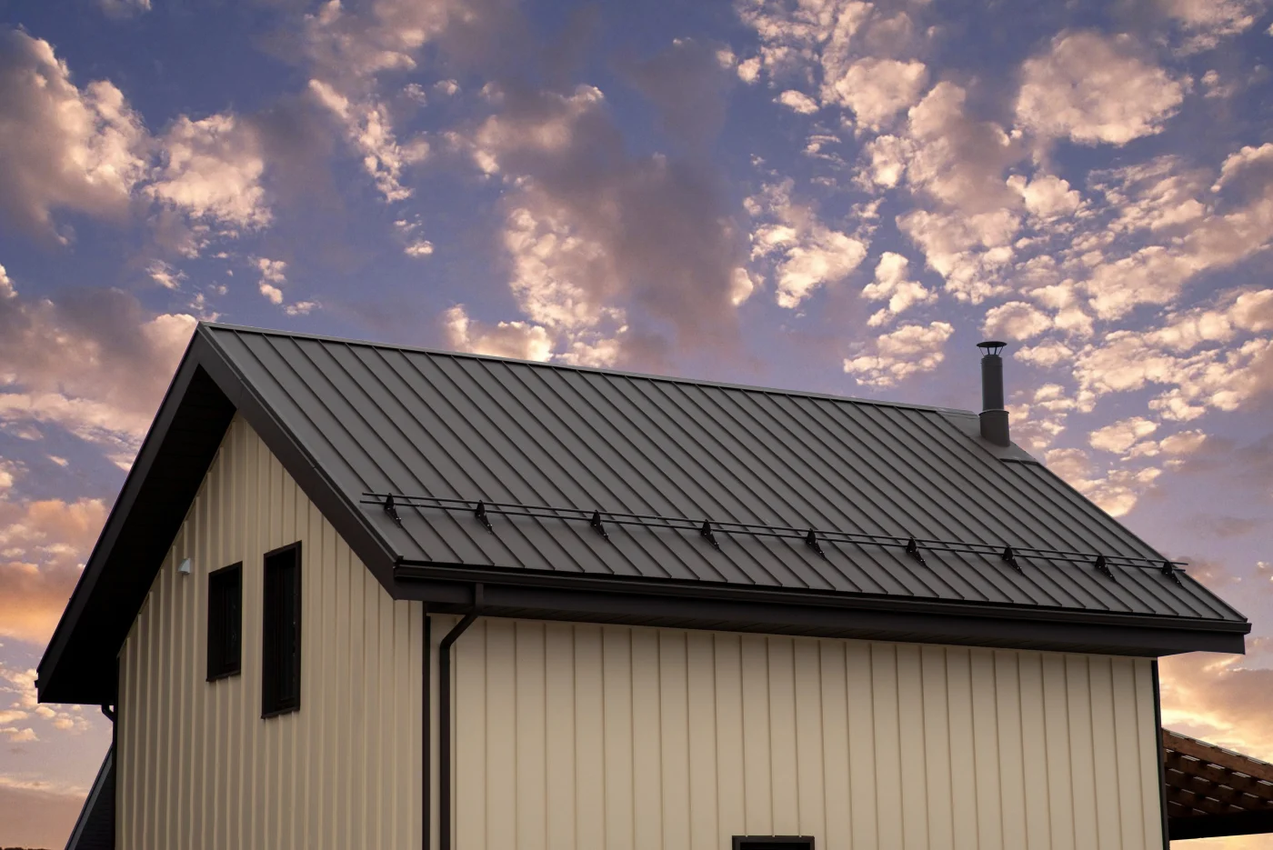 A brown standing seam metal roof replacement installed on a brick home in Bee Cave, TX.
