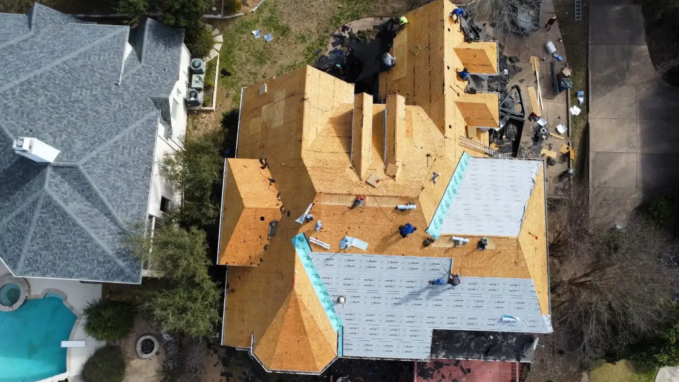 Front view of a brick home with a newly installed shingle roof.