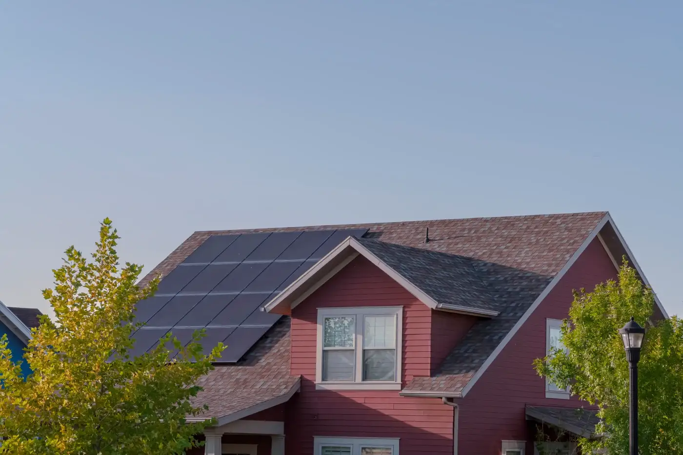 Solar panels installed next to a dormer window.