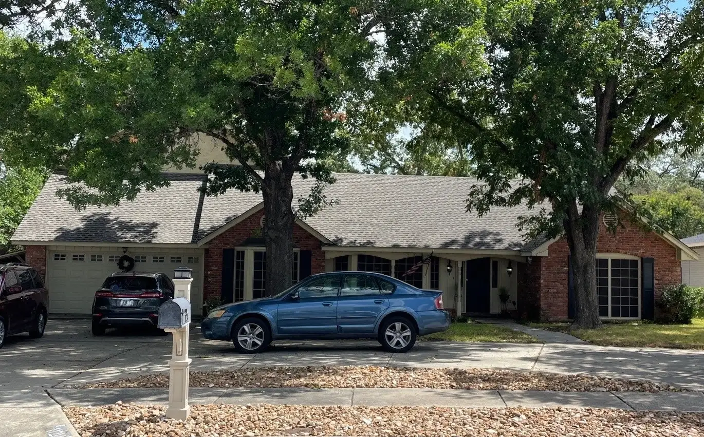 A brick home with architectural asphalt shingle roofing.