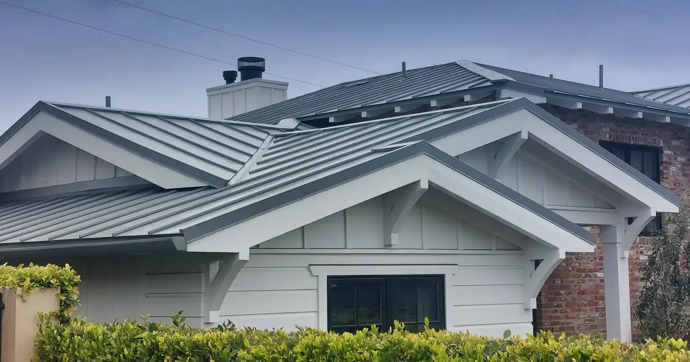 A stone-sided home with a metal roof.