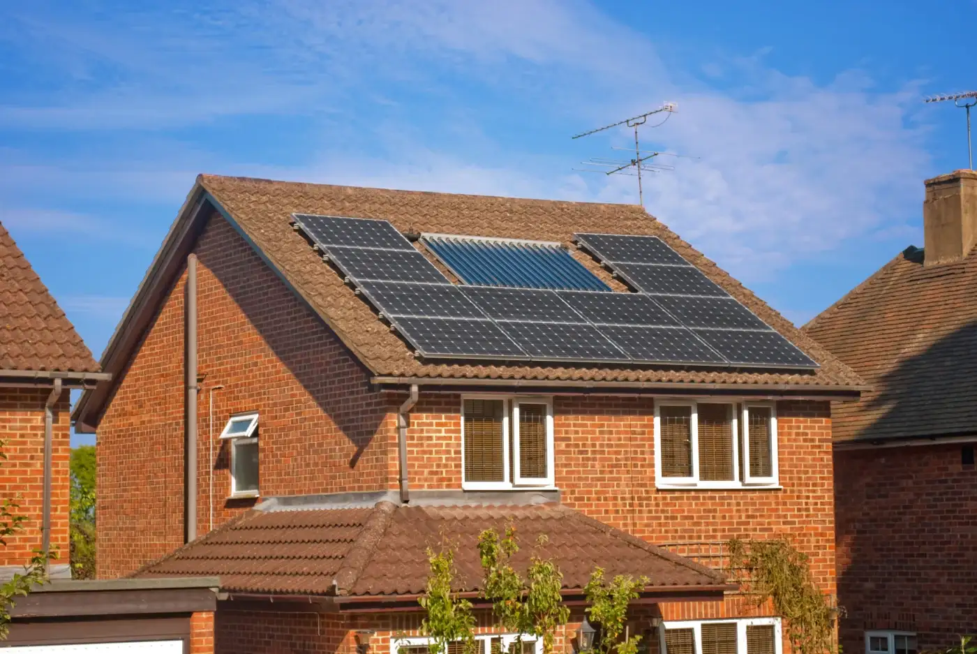 A home with white siding, light gray shingle roofing, and solar panels.