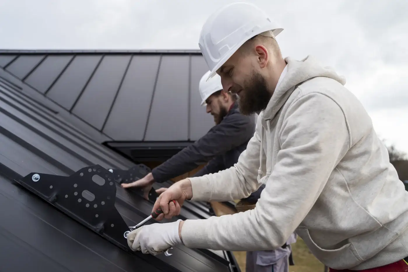 A roofing contractor verifies the lines on a metal roof.