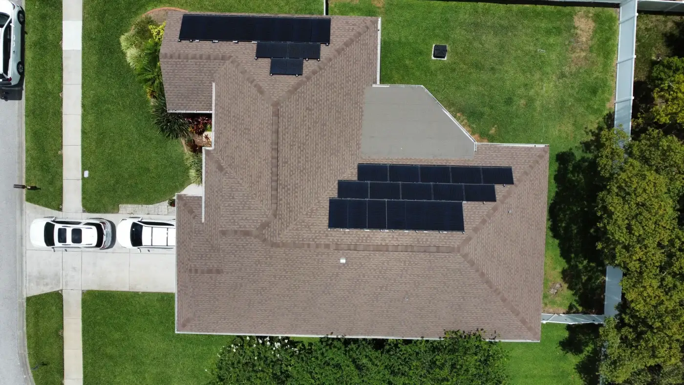 A home with blue and cream siding, white trim, and solar panels.