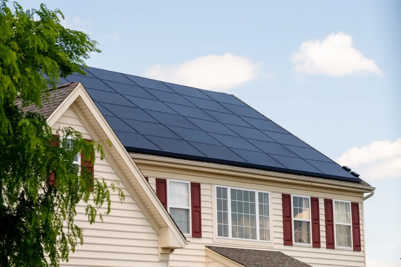 Close-up of solar panels on a gray shingle roof.