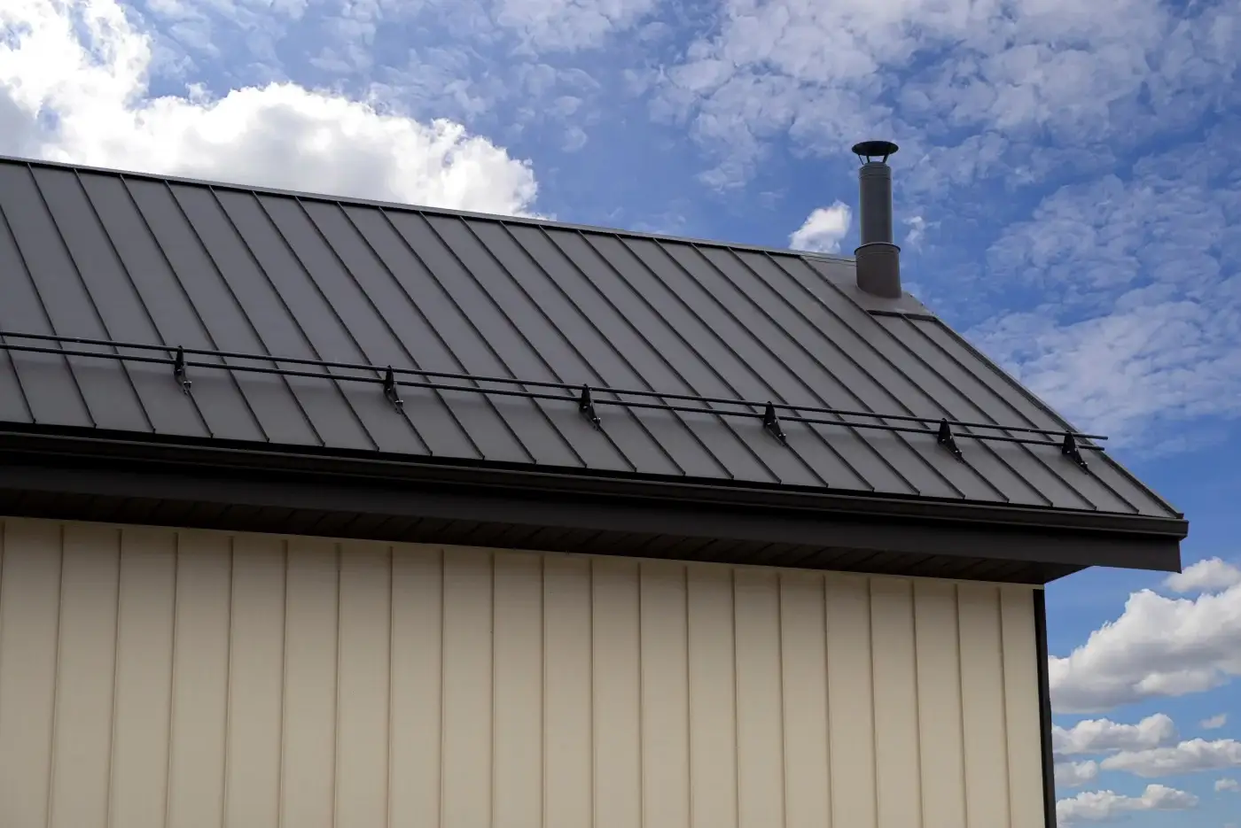 A roofing contractor completes a checklist after a metal roof installation.